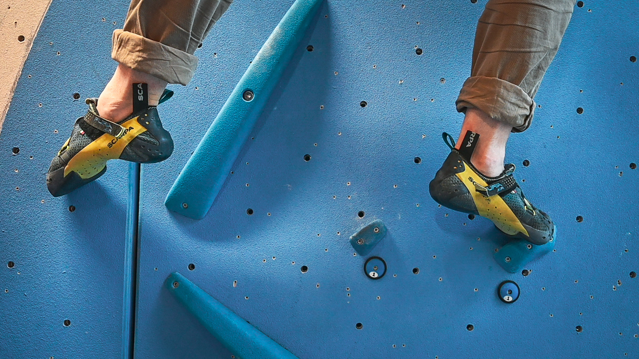feet on a climbing wall